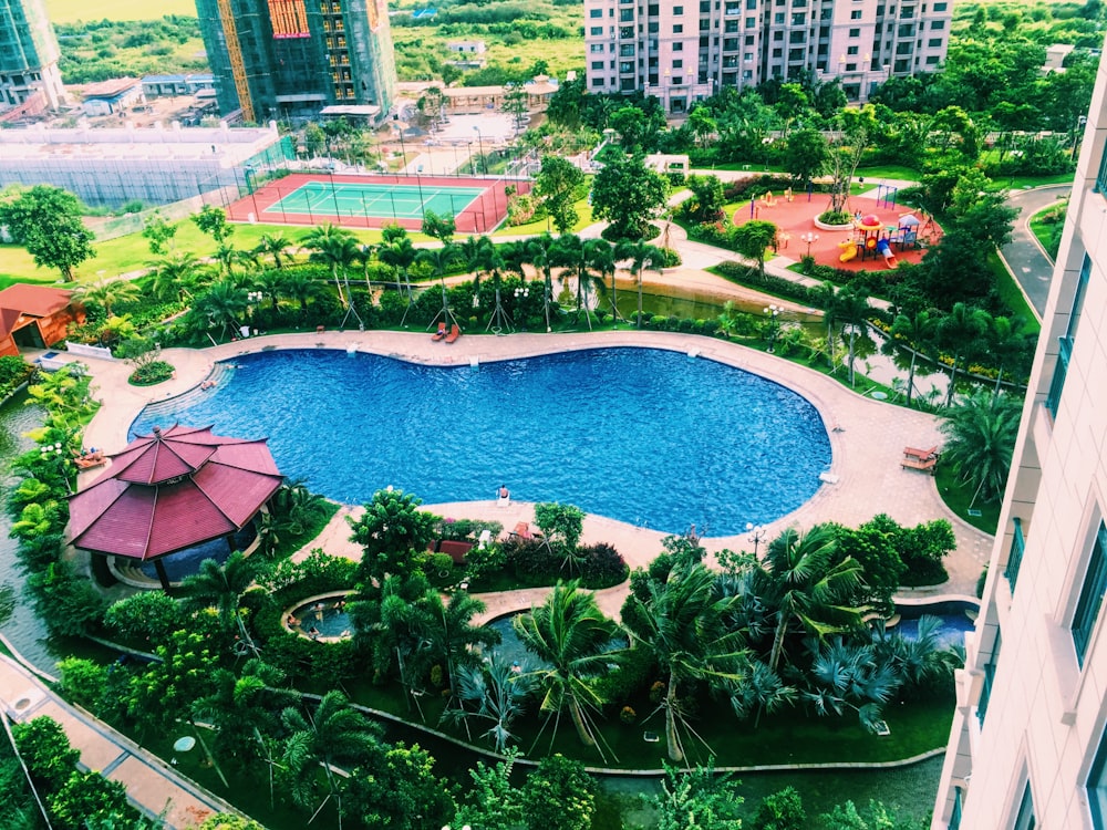 pool near buildings and tennis court