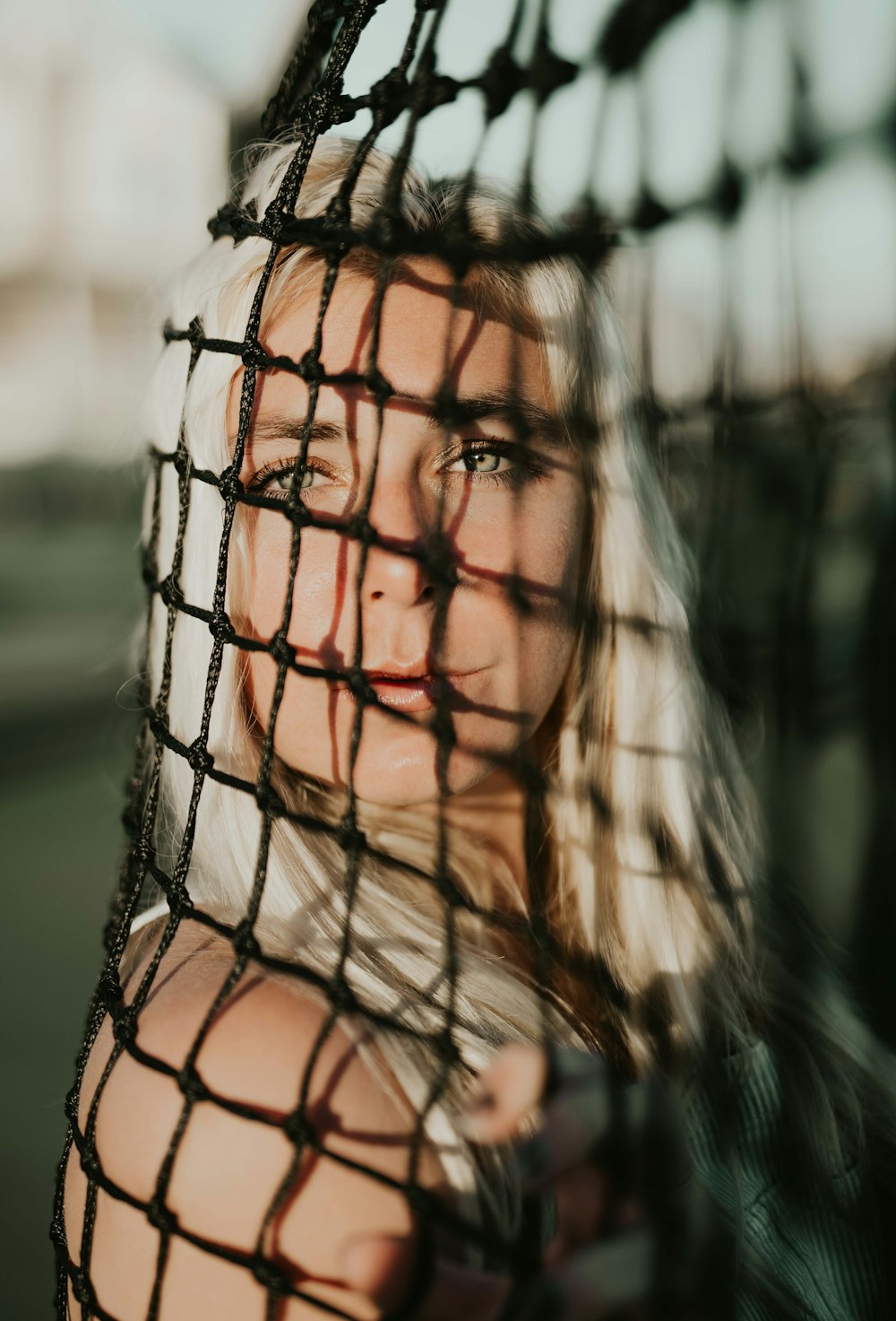 unknown celebrity leaning on black goal