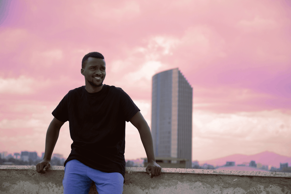 man sitting on concrete wall