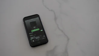 A smartphone displaying noirstream's minimalistic music streaming homepage in dark theme.