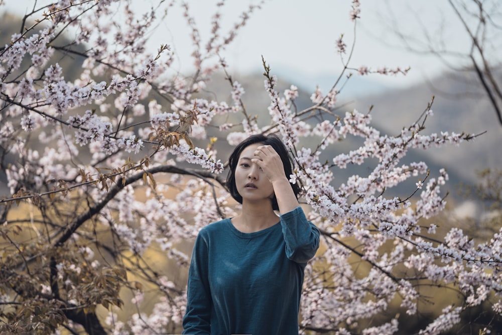 woman standing near flower