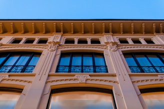 Before and after view of a building facade transformation, showcasing the quality and reliability of our finishing work.