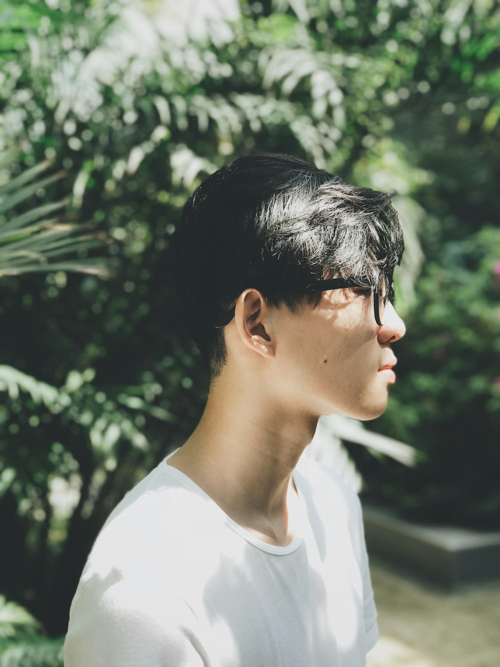 man wearing white crew-neck T-shirt and eyeglasses