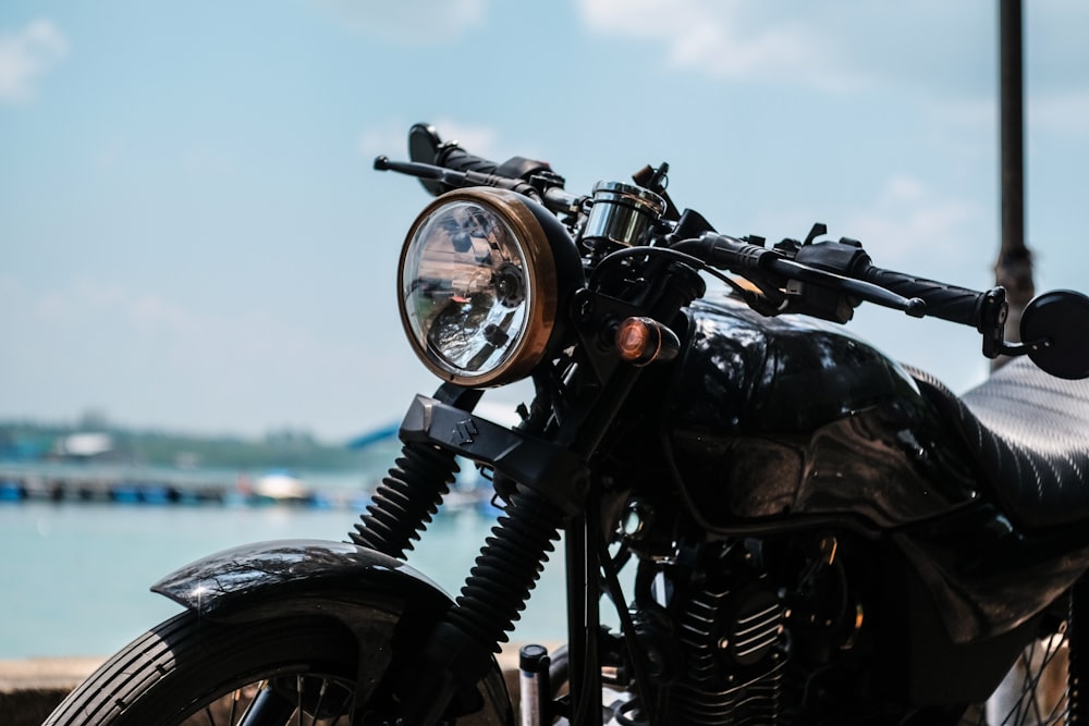 black motorcycle near body of water