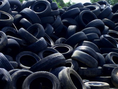 Truck loading used tires outside an auto repair shop.