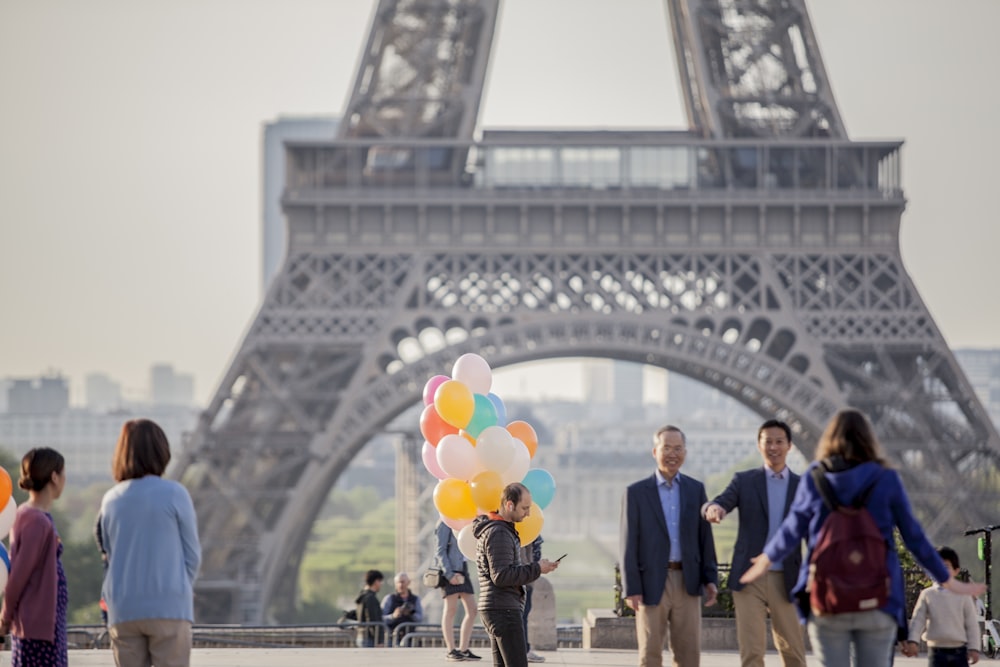 people standing near the Eiffel Tower during daytime