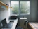 Happy student unpacking in a cozy New Zealand apartment arranged by Rams.