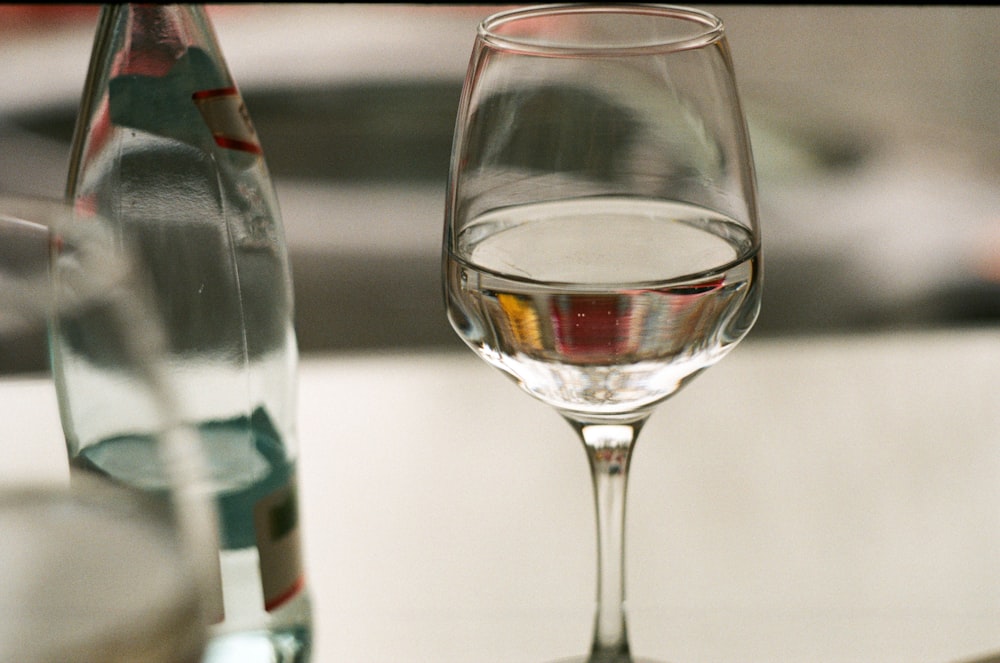 long-stem wine glass filled with white liquid