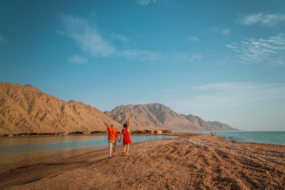 two person walking under blue sky