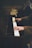 person about to play white and black piano