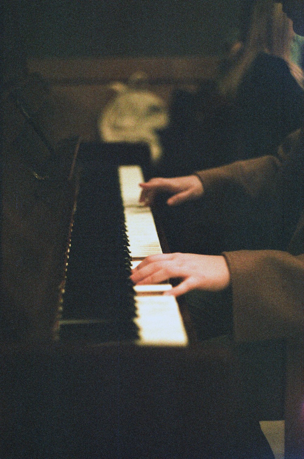 person about to play white and black piano