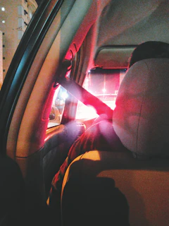 Interior view of a spacious, comfortable taxi seat with seatbelt fastened.