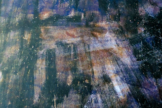 Close-up of a dark abstract oil painting with rich textures and deep shadows