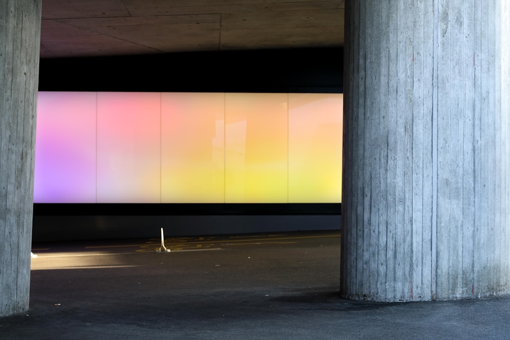 an empty parking garage with a large screen on the wall