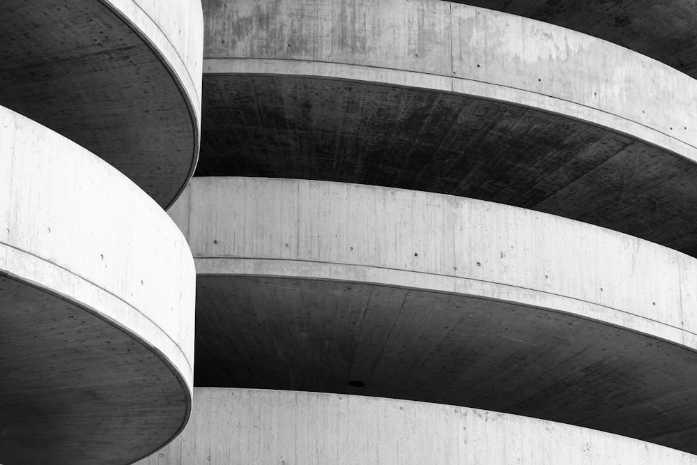 a black and white photo of a curved building