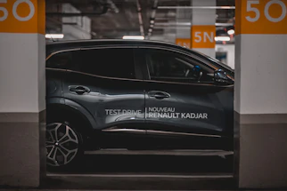 A sleek Renault car parked by a scenic countryside road, ready for a memorable driving experience.