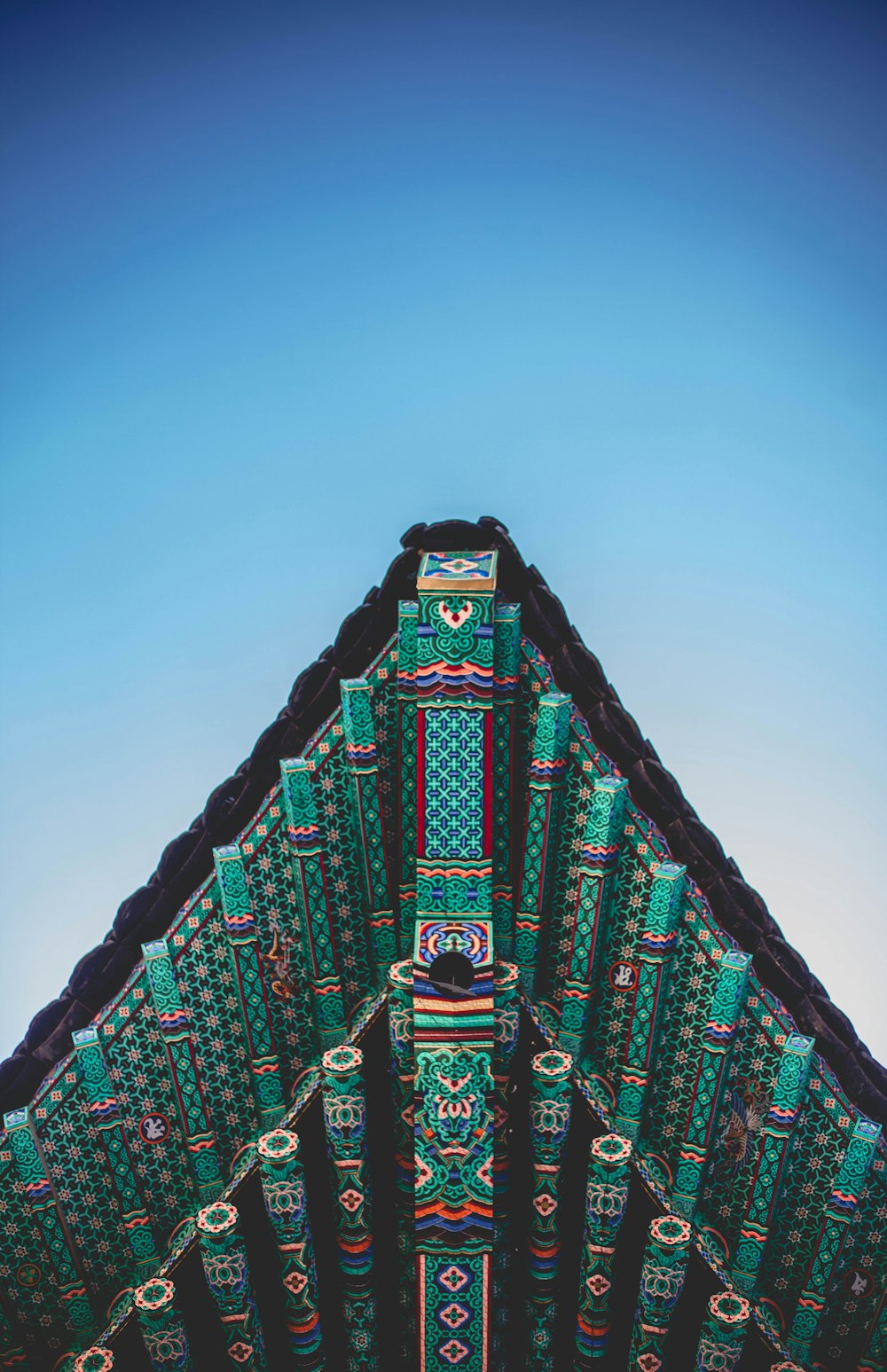 the roof of a building with a blue sky in the background