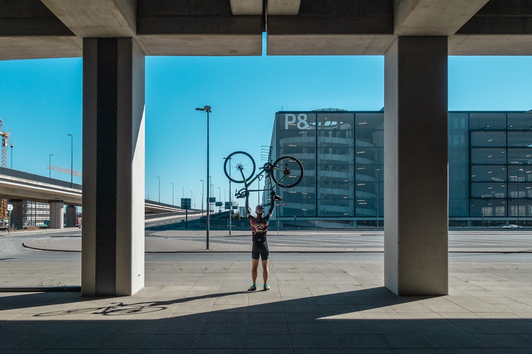 man carrying his bicycle