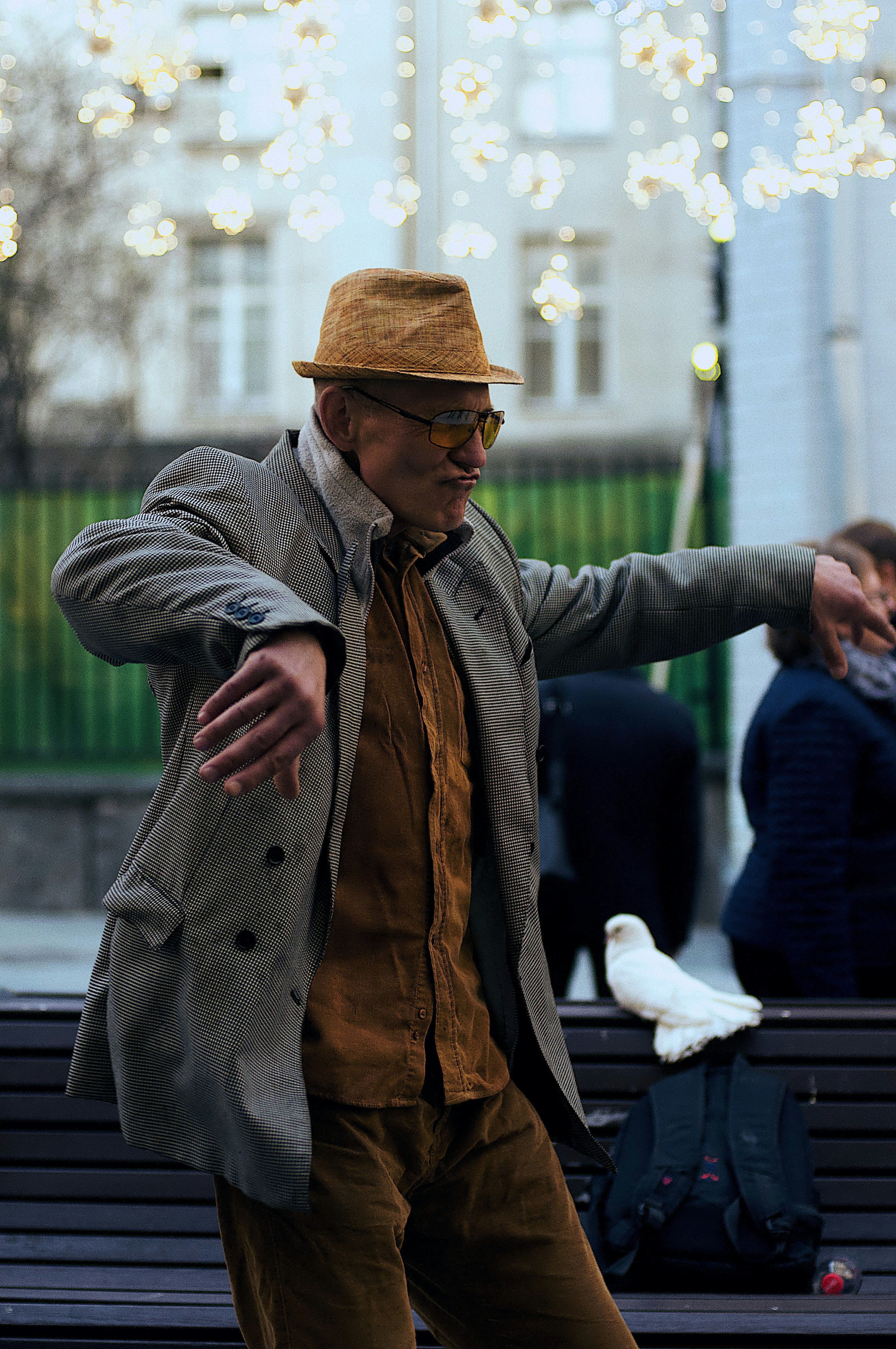 man standing and dancing near people