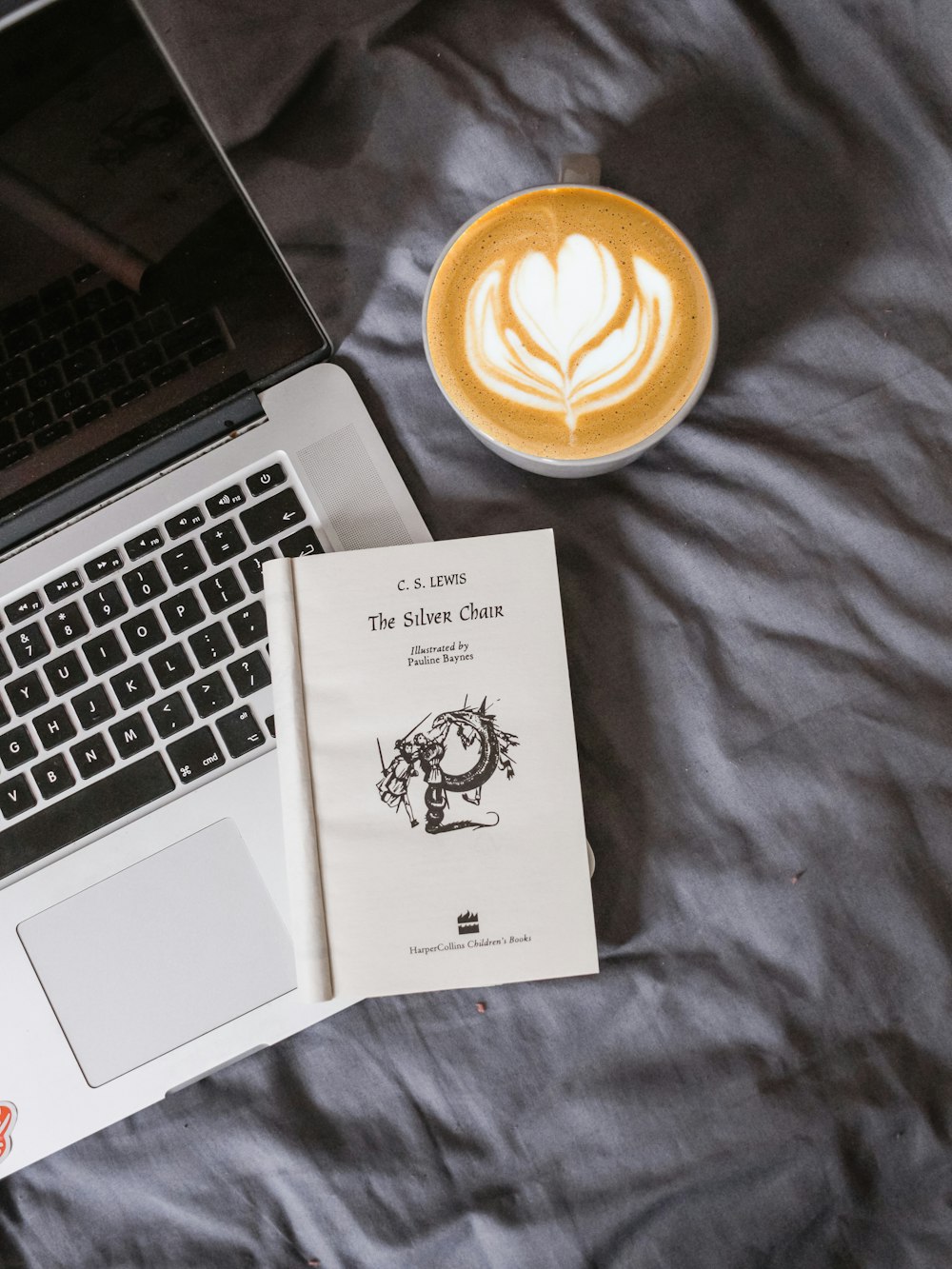 white book on top of MacBook Pro