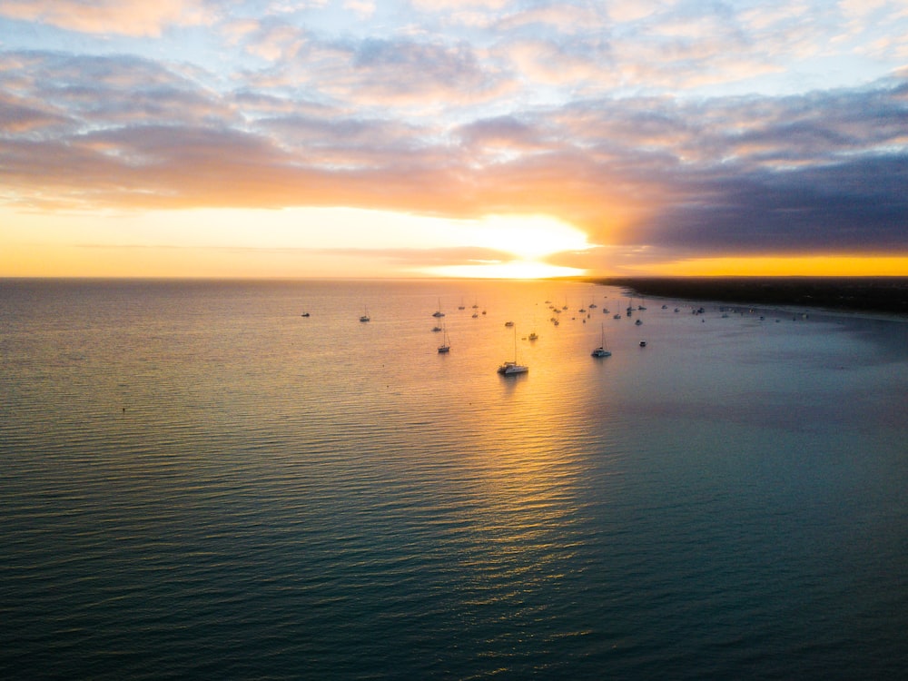 body of water during golden hour under cloudy sky