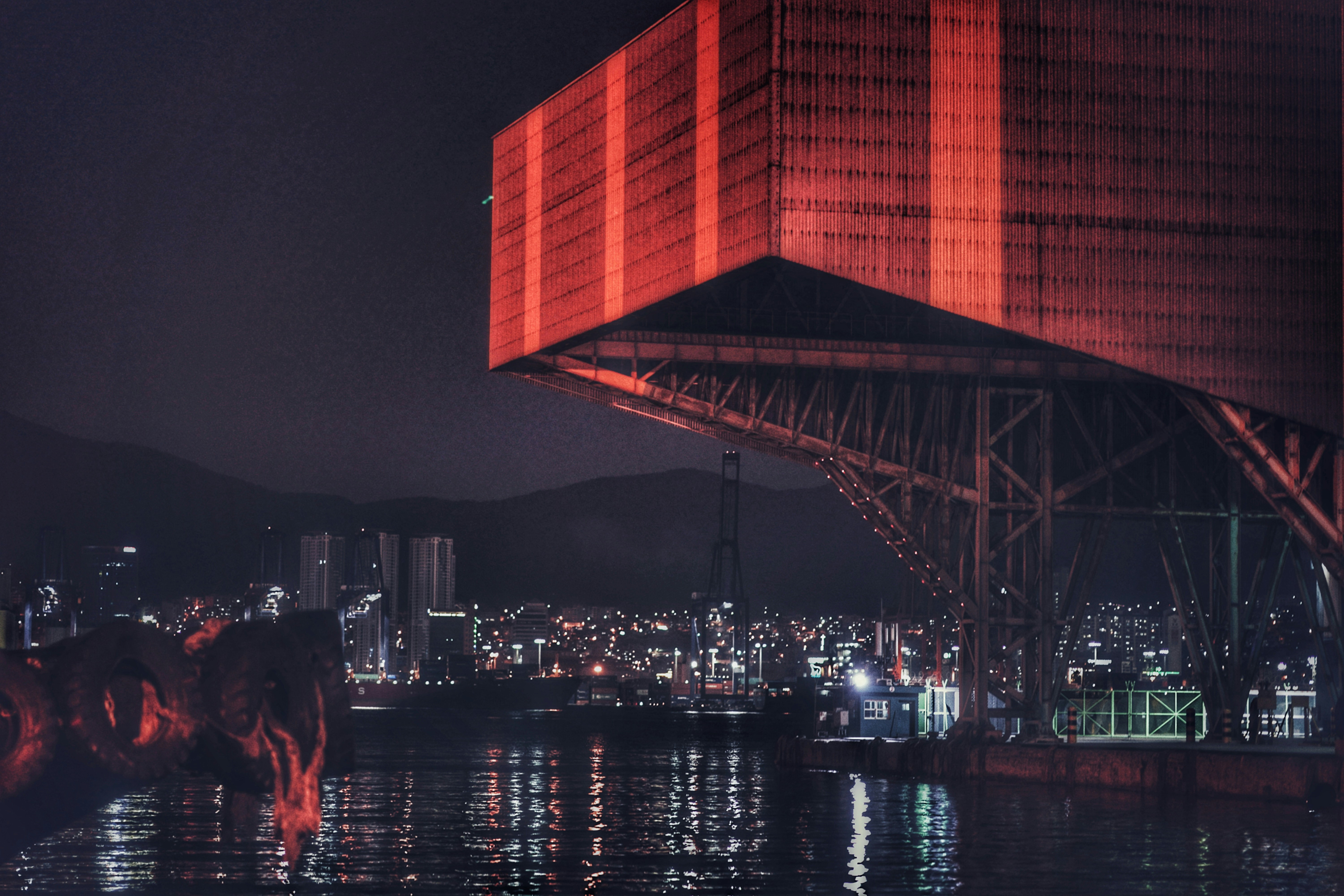 Red and gray concrete building during nighttime photo – Free Building ...