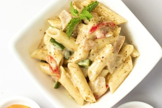 sauced penne pasta dish on bowl