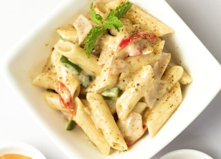 sauced penne pasta dish on bowl