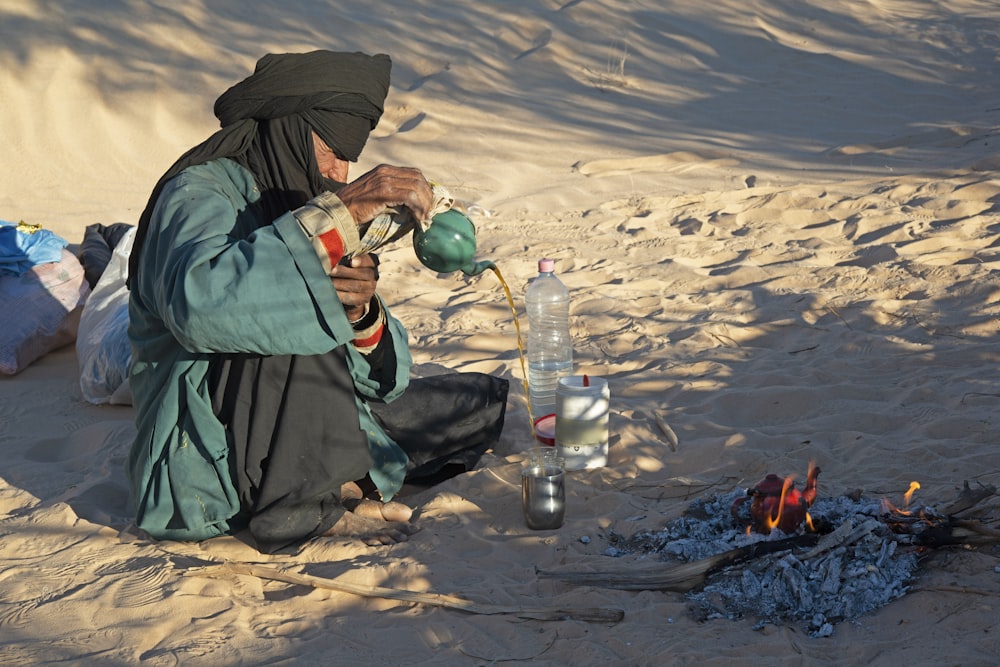 person pouring liquid in bottle