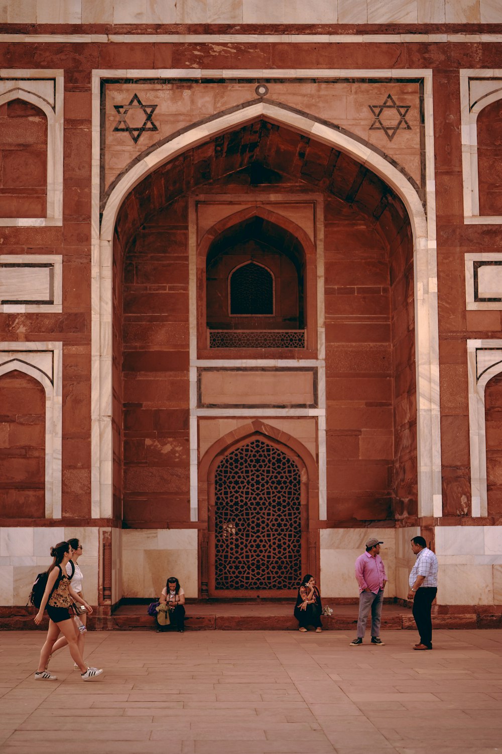 men standing beside brown structure