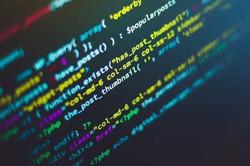 Lines of colorful code are displayed on a dark background, showcasing various programming functions and syntax. The text is highlighted in different colors to indicate different parts of the code, which includes strings, variables, and functions.