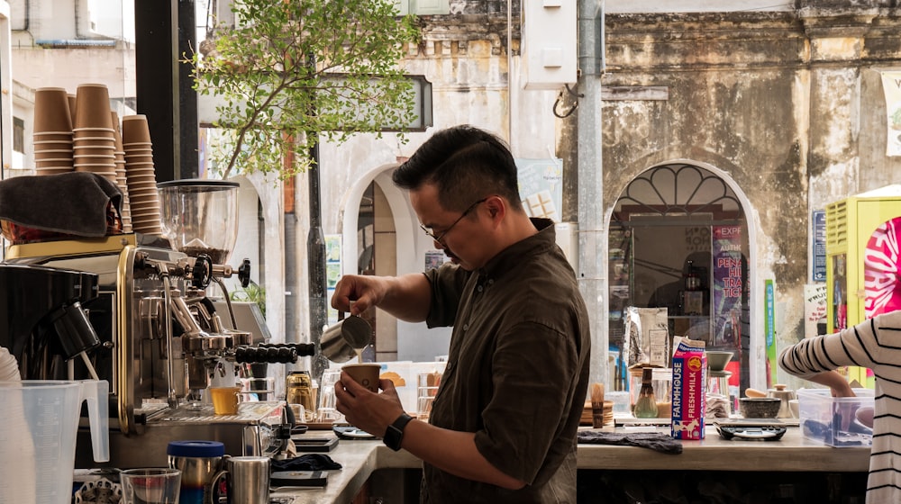 man filling tea cup