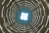 Abstract representation of encrypted data flowing through a secure digital tunnel.