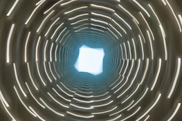 Abstract representation of encrypted data flowing through a secure digital tunnel.