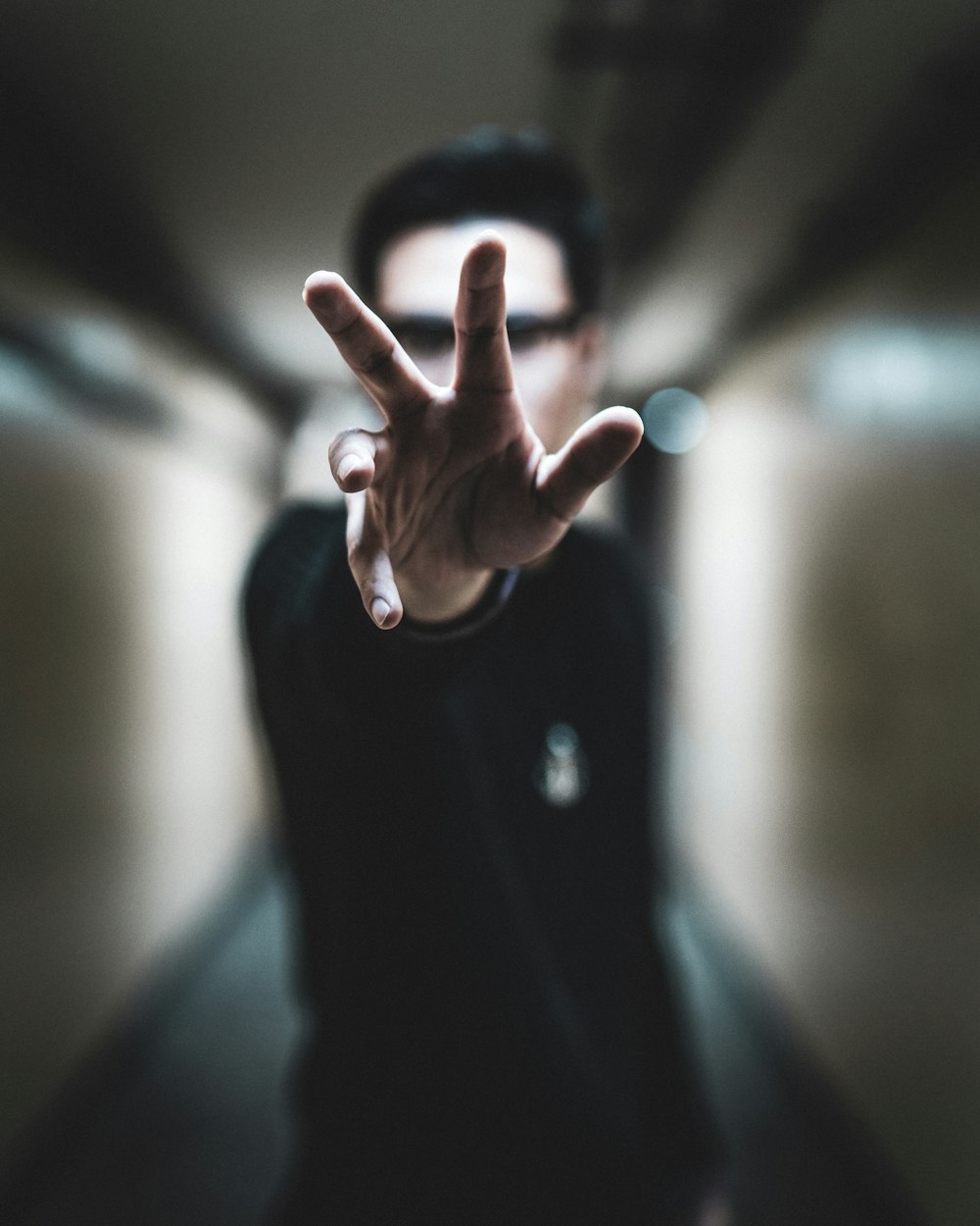 shallow focus photo of person reaching right hand