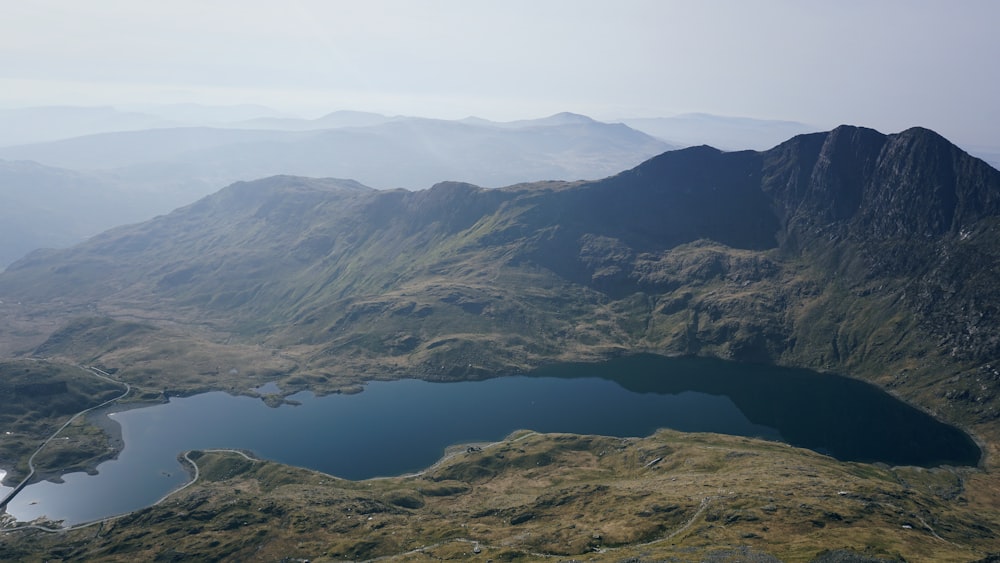 green covered mountain and lake