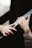 Two hands are reaching towards each other with an emotional and gentle gesture. The surroundings are blurred, focusing attention on the hands.