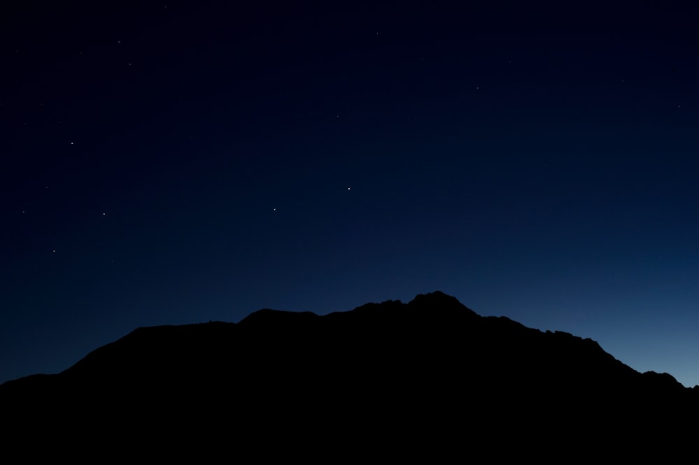 silhouette of mountain during nighttime