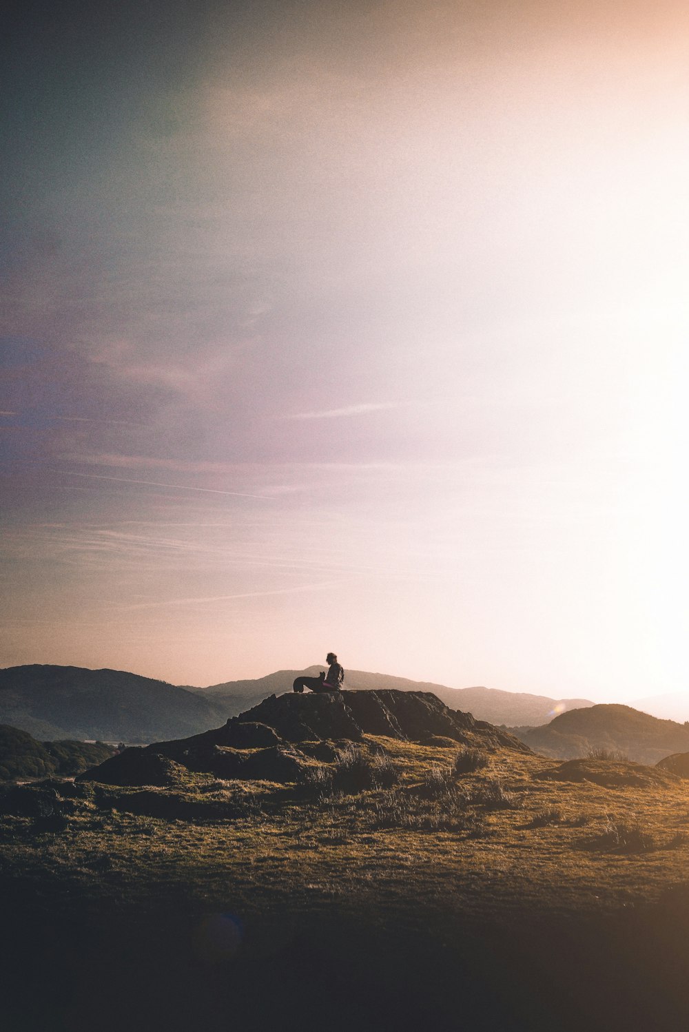 man sitting on mountain