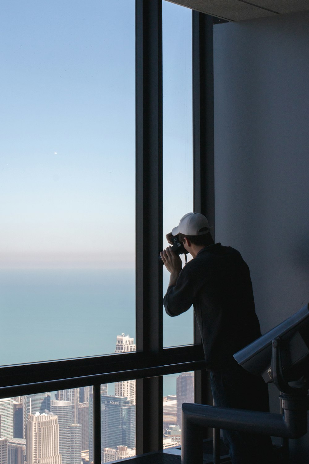 man wearing black dress shirt taking photo