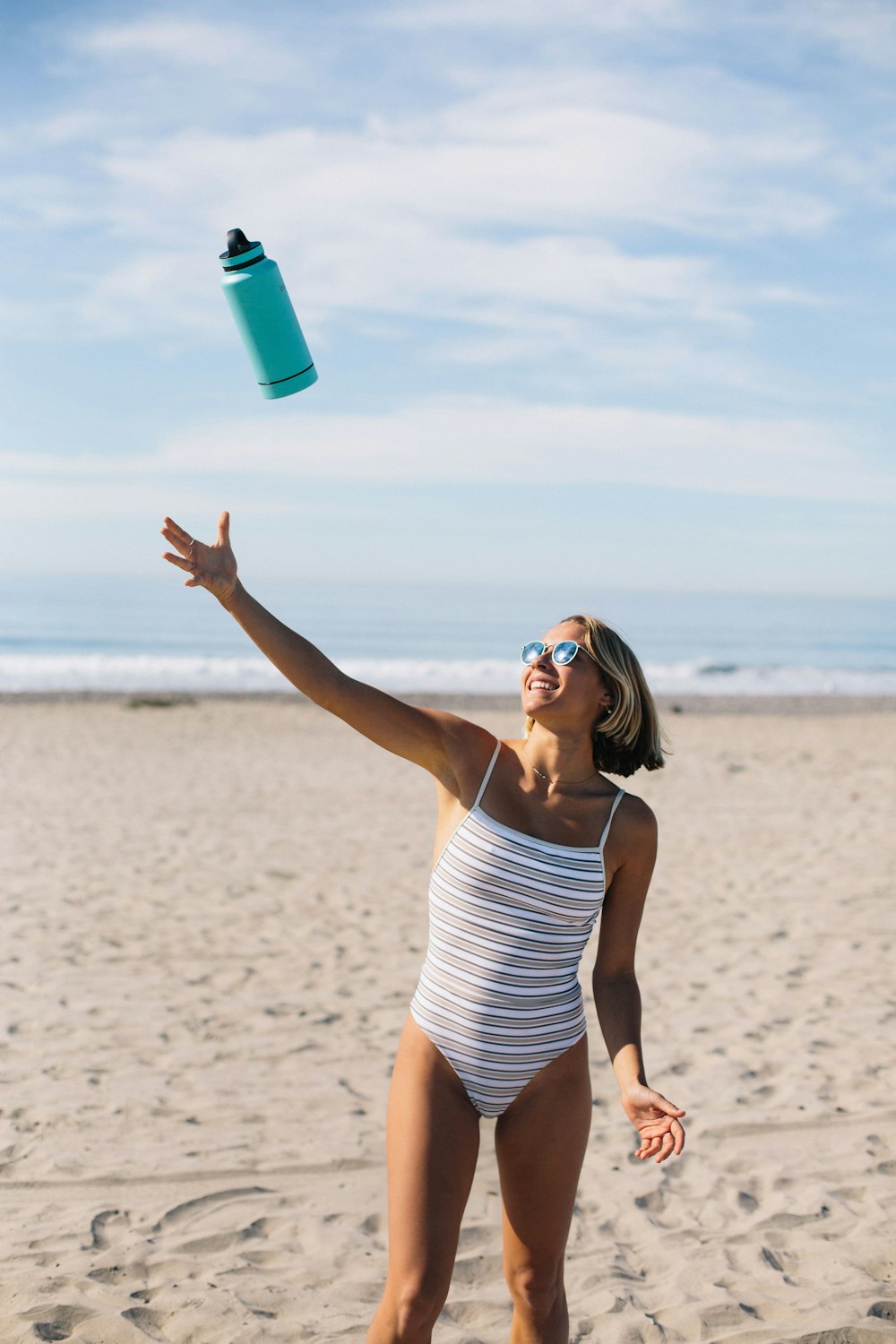 woman throwing blue tumbler