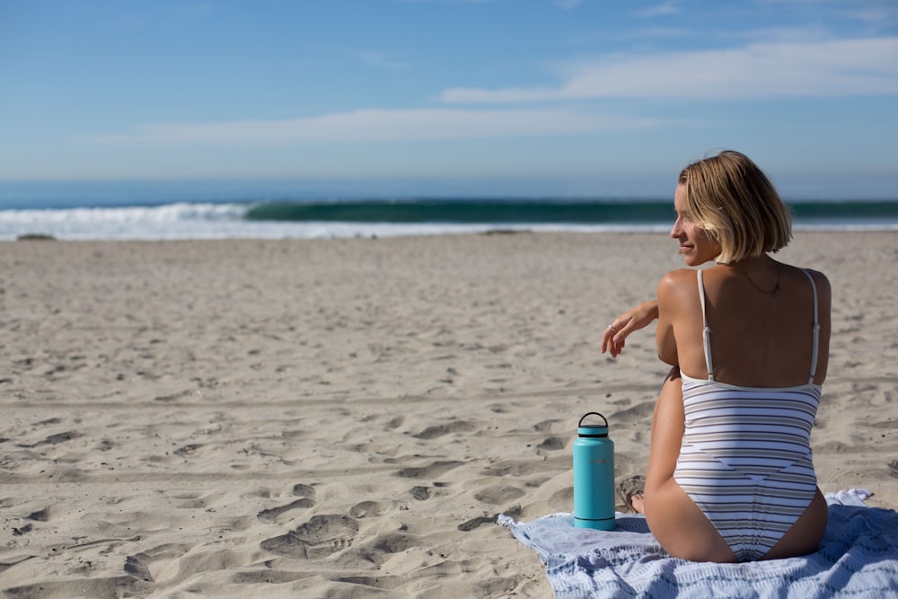 woman sitting in front of shoreline