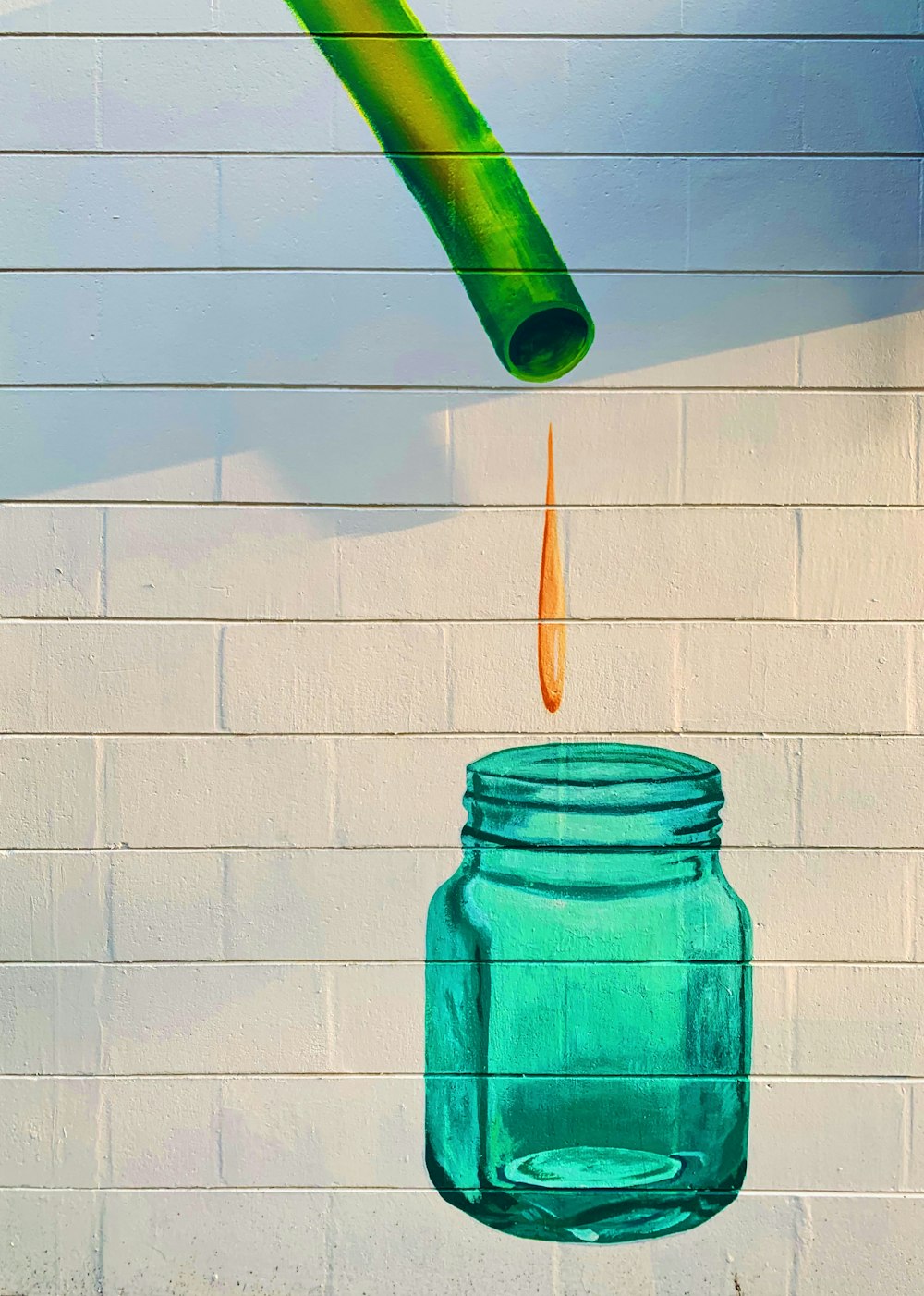teal printed jar on concrete wall