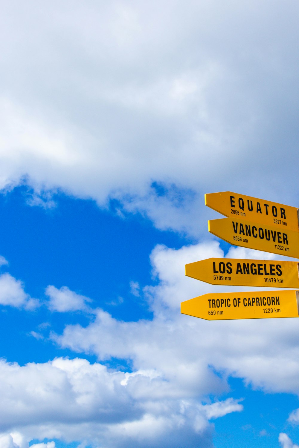 four yellow road signages during daytime