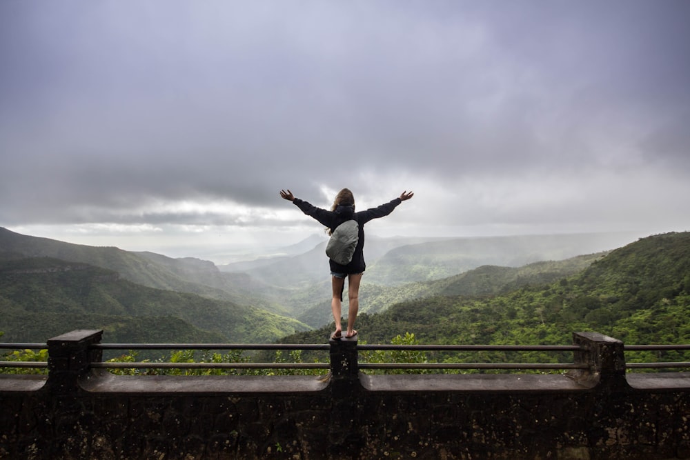 person standing on concrete railings