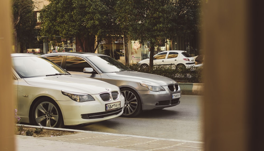 white BMW vehicle on gray top road