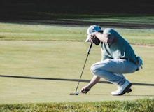 man holding black golf club