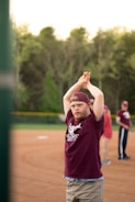 man standing and raising his both hands