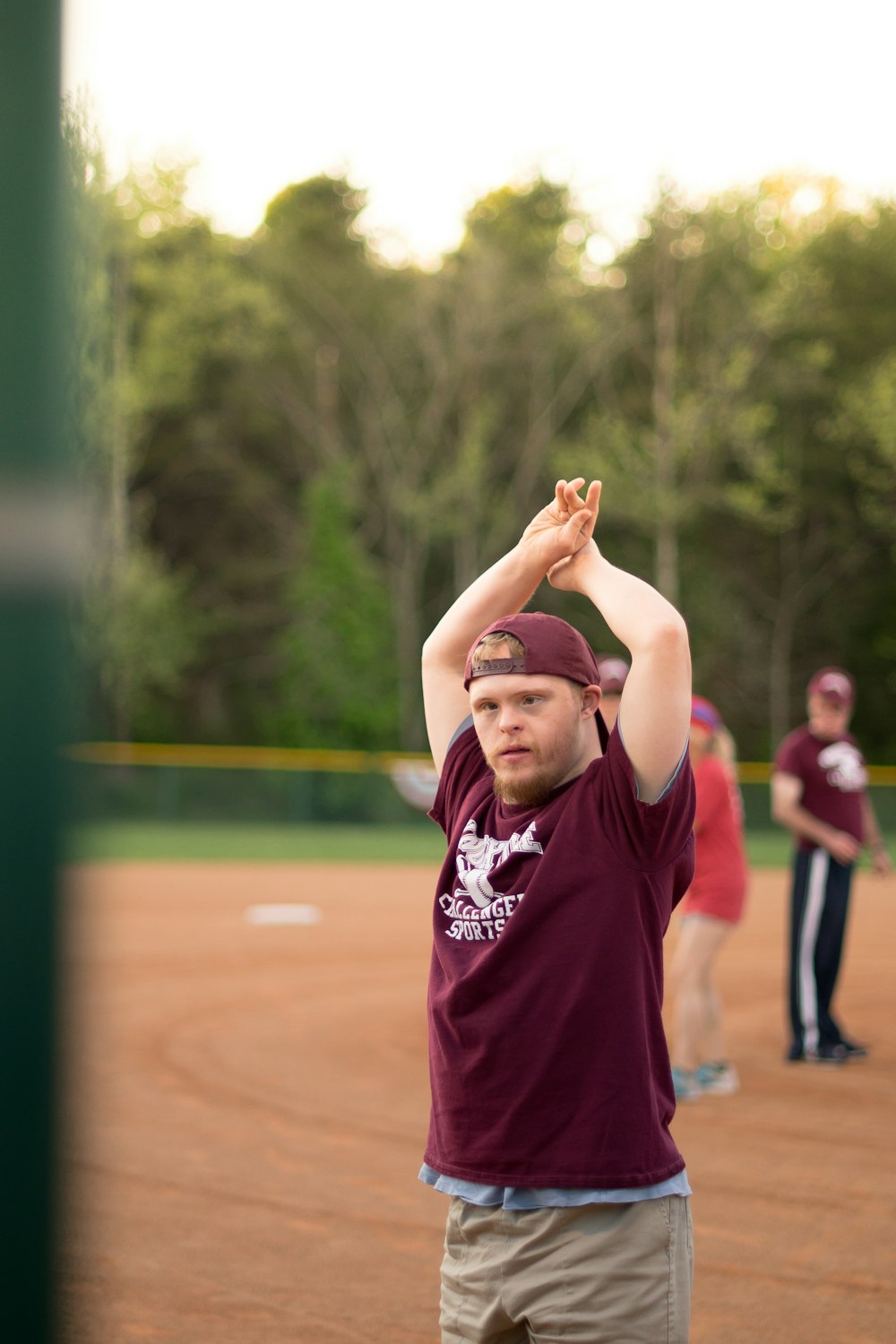 man standing and raising his both hands