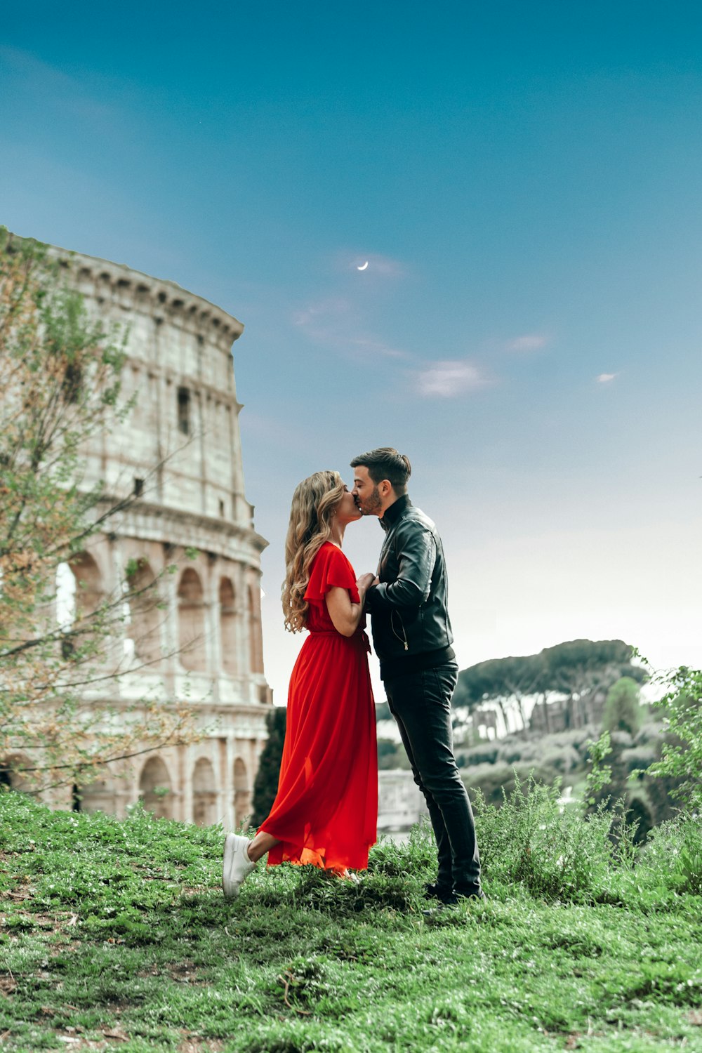 man and woman standing on grass